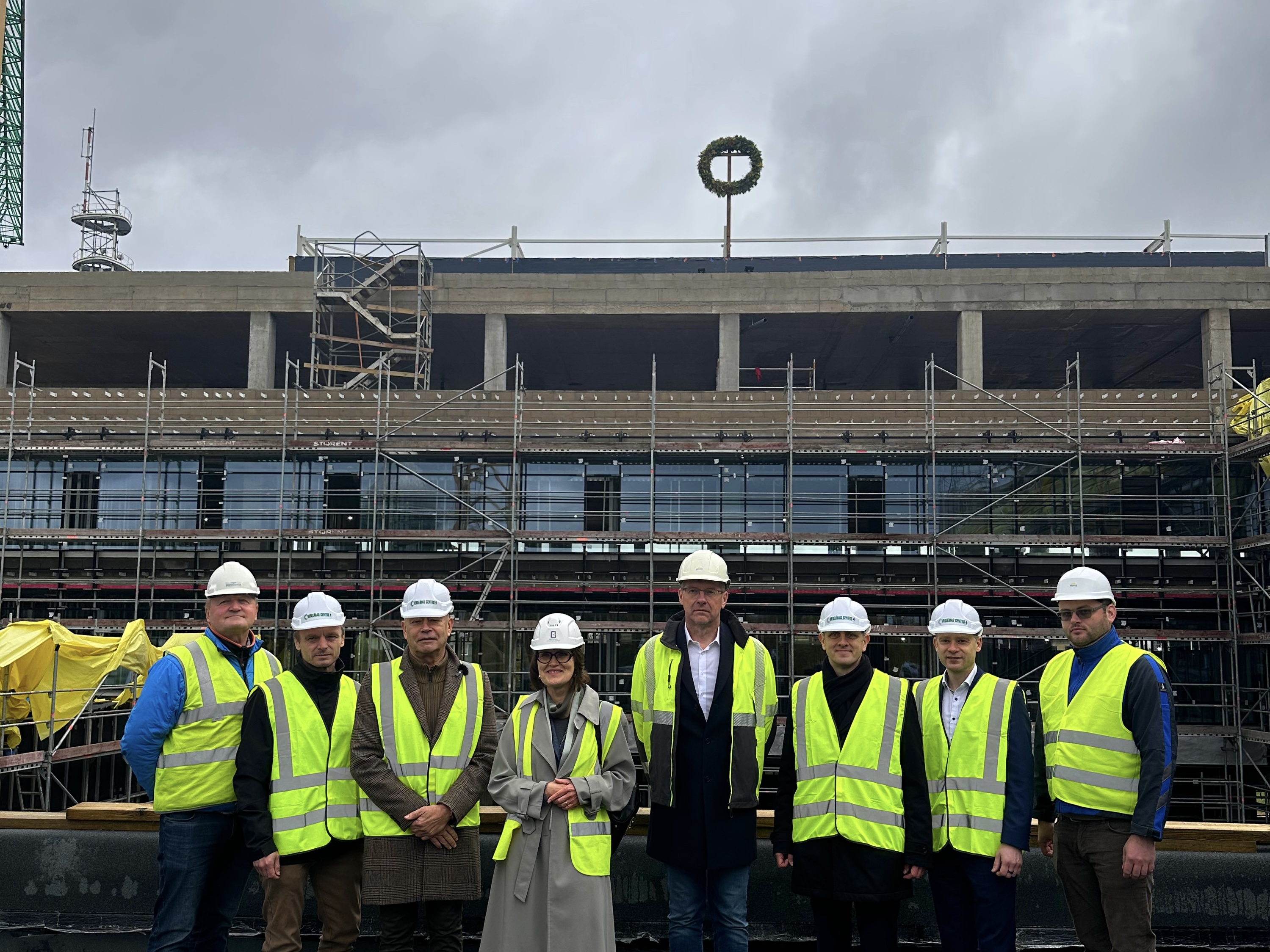 Būvniecības projekta komanda pie jaunbūves spāru svētku laikā